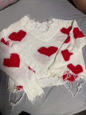 Distressed White V‑Neck Sweater with Red Heart Pattern